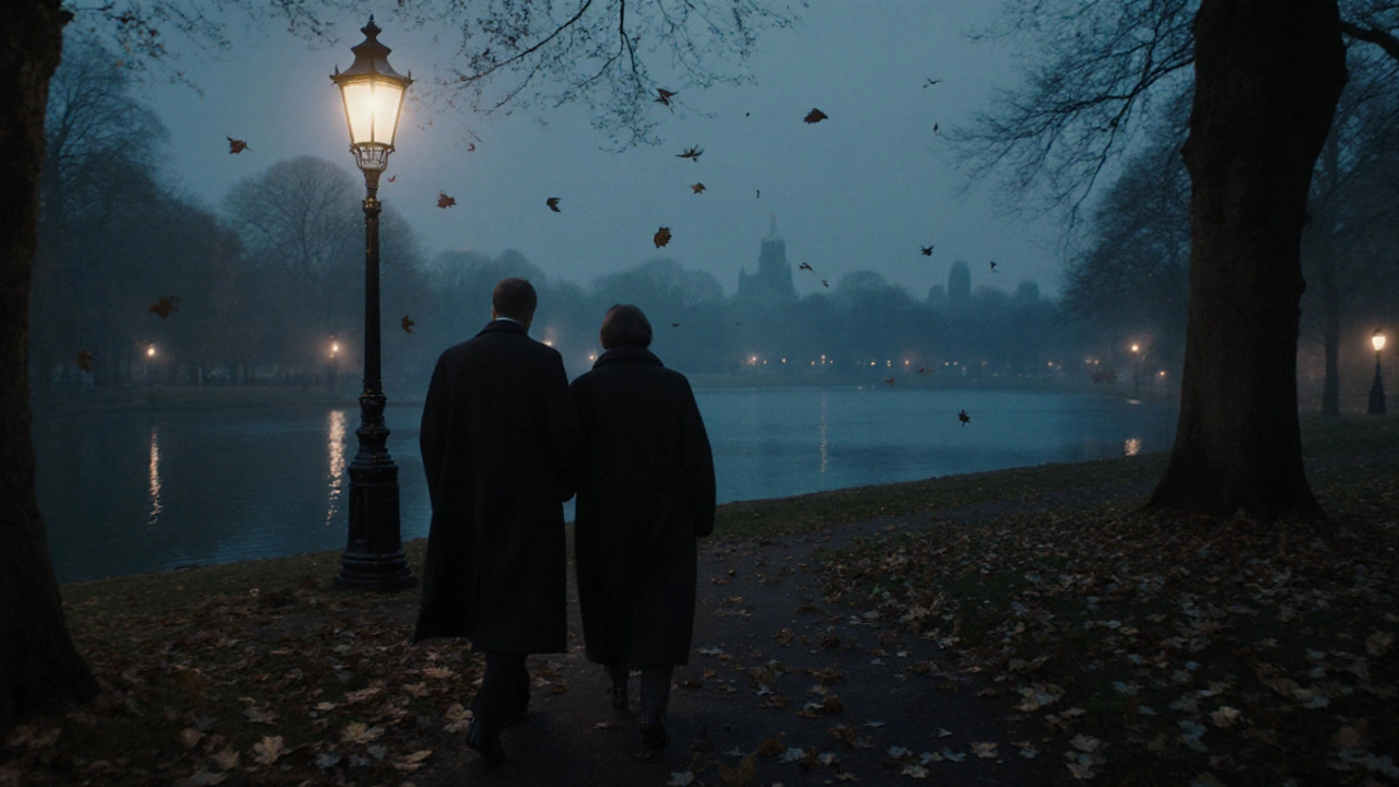 A couple walking quietly through Hyde Park at dusk under lanterns