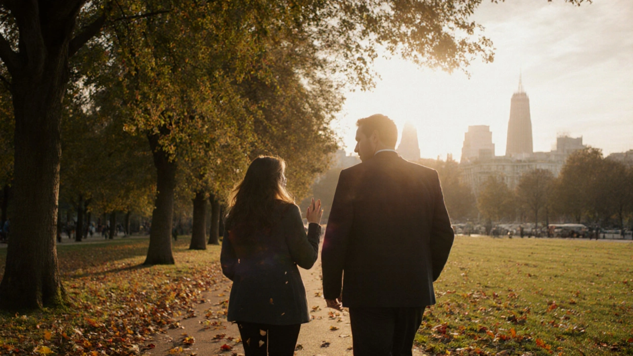 A man and woman walking peacefully through Hyde Park at sunset, autumn leaves falling around them.