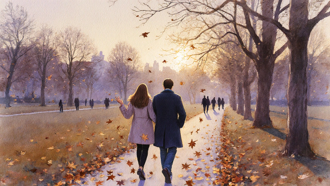 Couple walking peacefully along Regent’s Park path at sunset, autumn leaves falling around them.