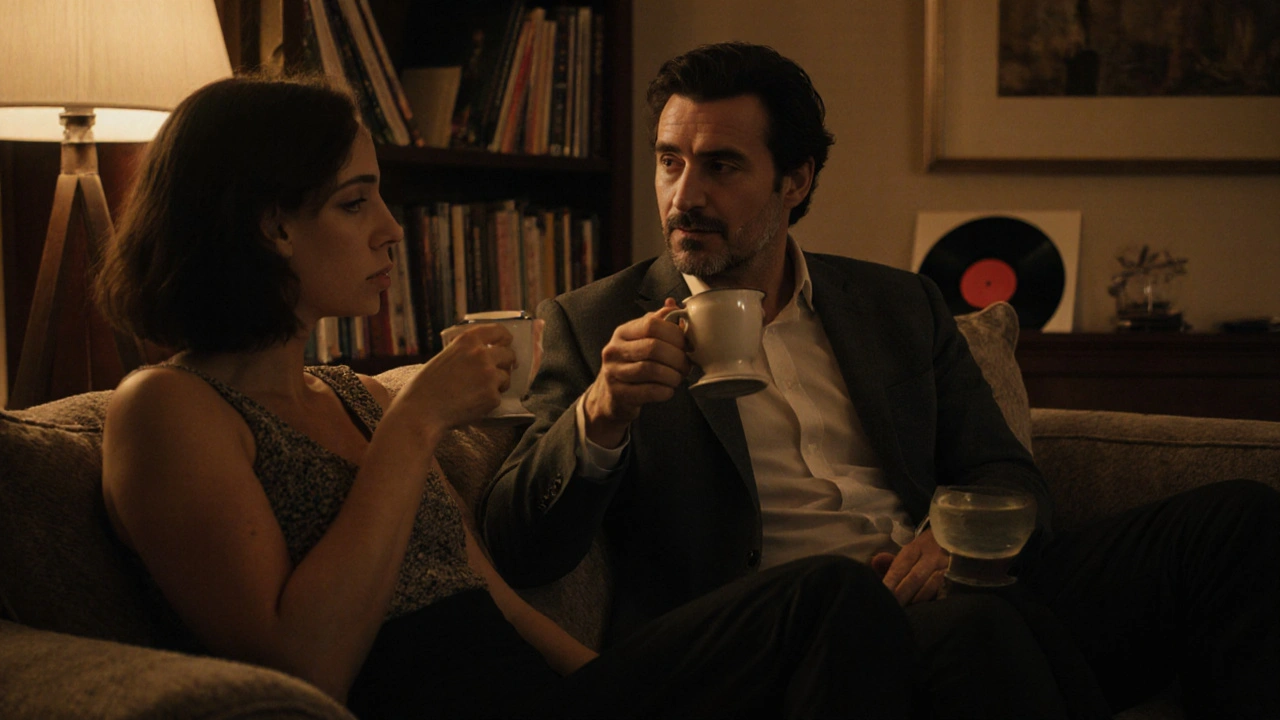 Two people sit comfortably on a couch, sharing tea in a quiet London living room, engaged in thoughtful conversation.