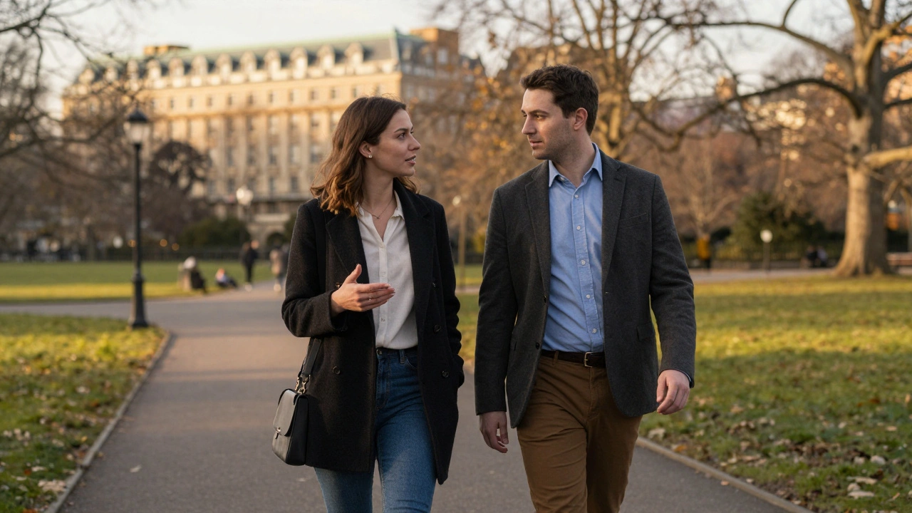 A man and woman walking peacefully side by side in Hyde Park during golden hour, engaged in quiet talk.