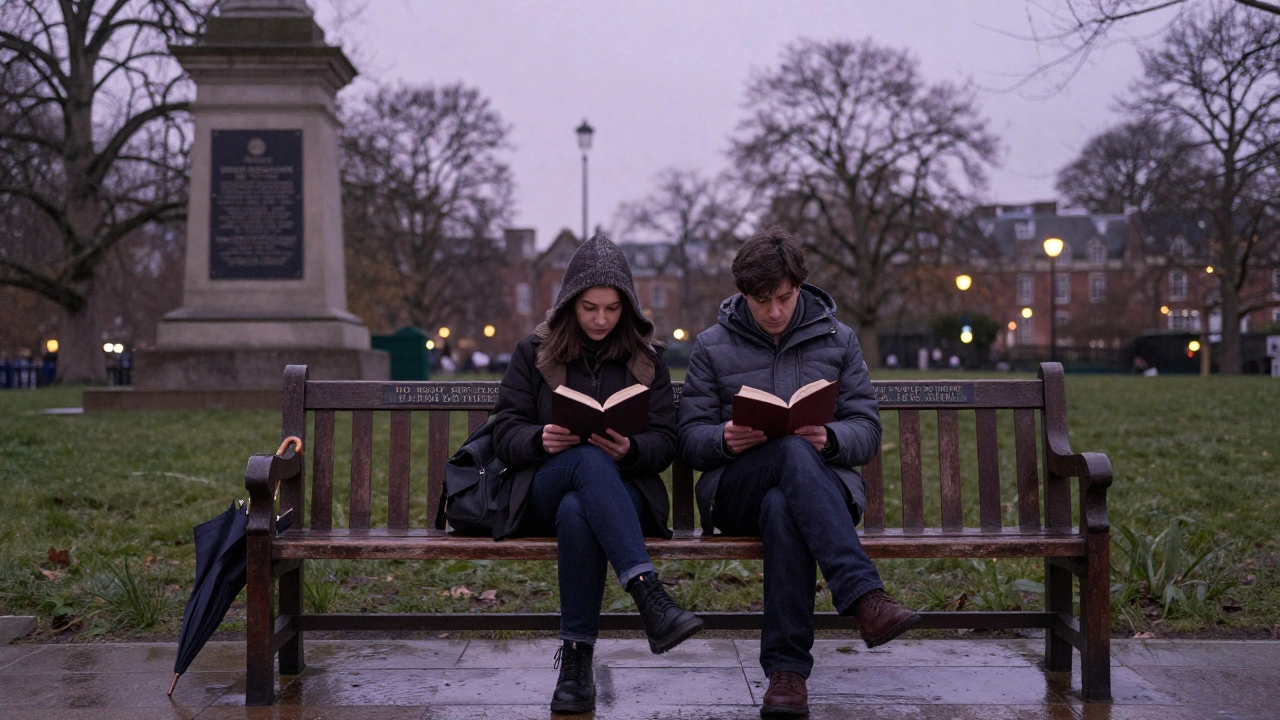 A couple sitting on a bench in Postman’s Park, reading memorial plaques as dusk settles and light drizzle glistens on stone.